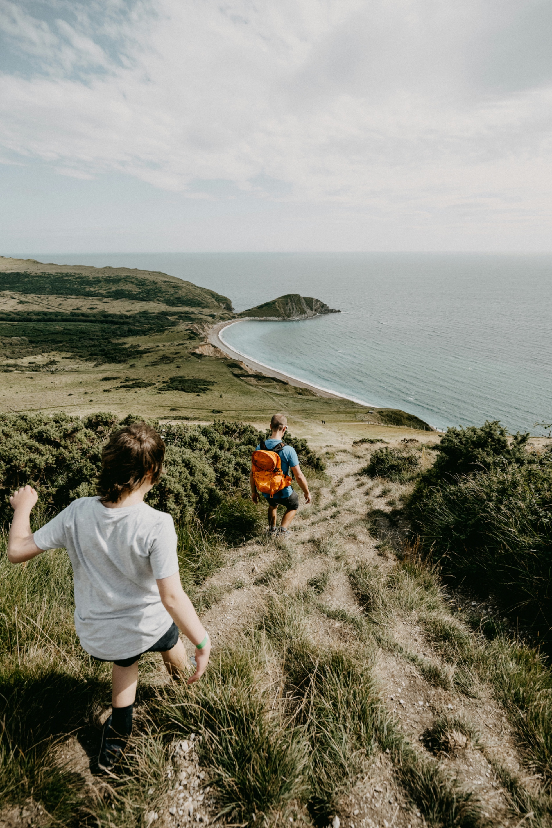 Father and child walking the Dorset coast path