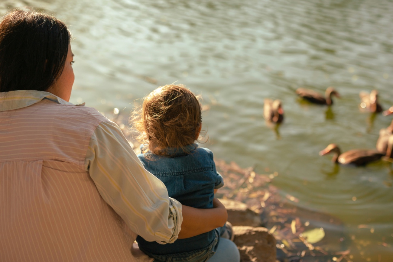 Mother and child by the water — representing a fresh start through mediation